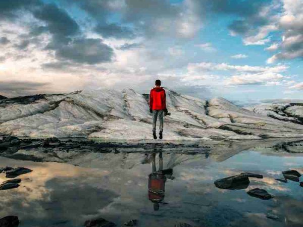 man standing near body of water of water